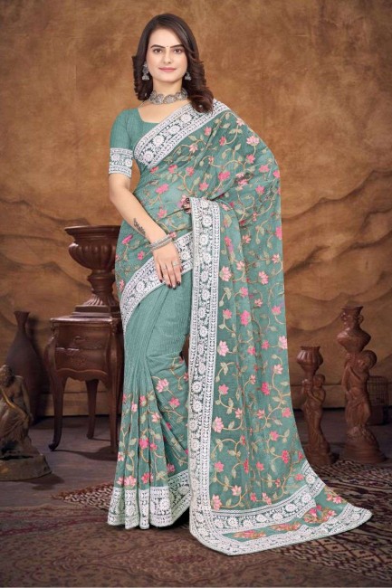weaving organza sari in dusty green